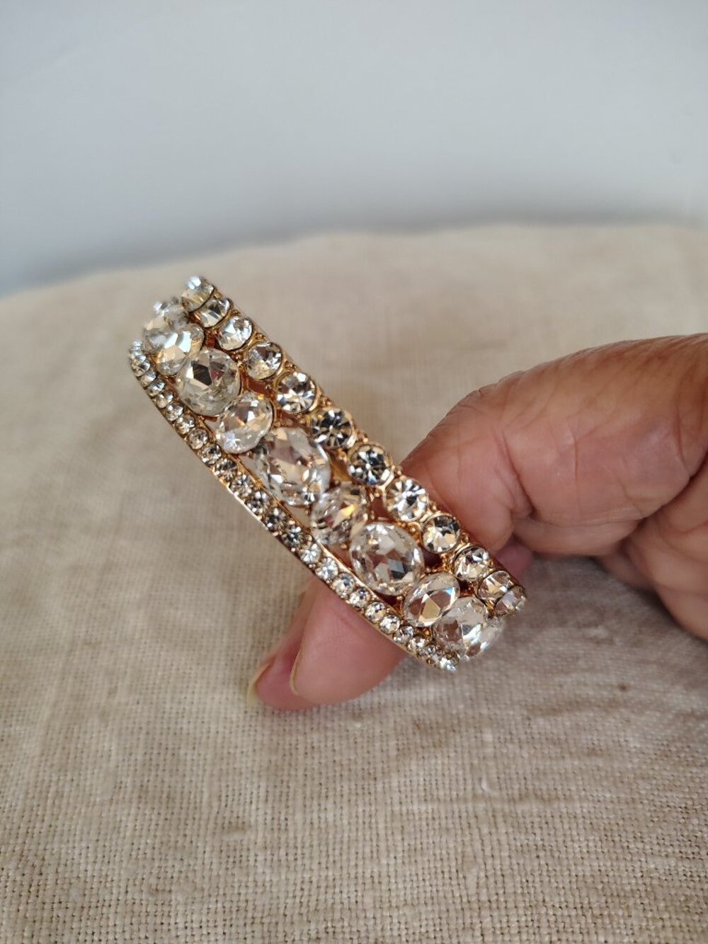 Gold Tone Hinged Bangle with multiple rows of large & small rhinestones